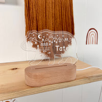Decorative lamp with bear design and custom name 'Tate' on a wooden base, placed on a shelf.