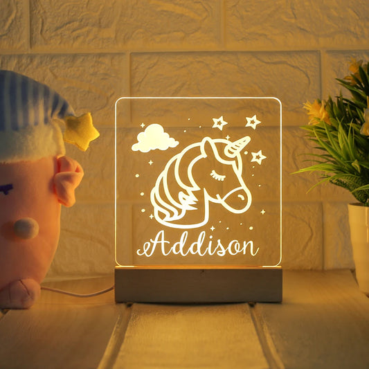 Unicorn-themed night light for kids with name and date and a wooden base